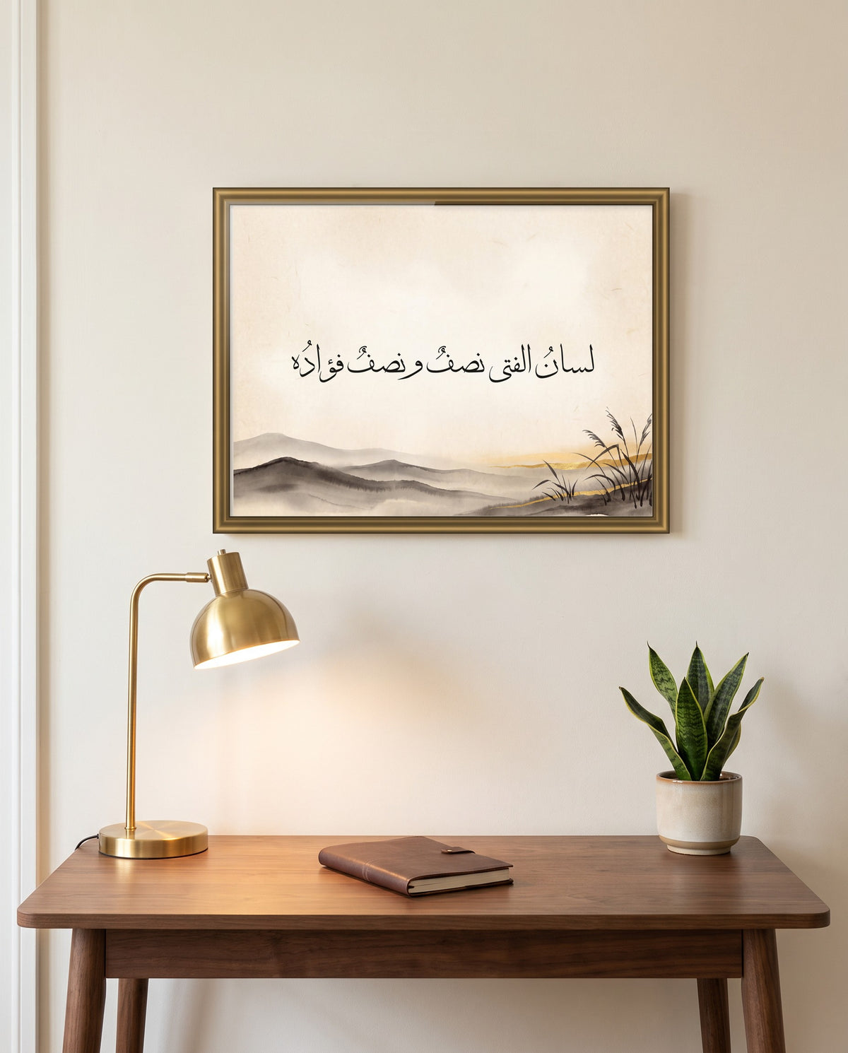 A Person Is Half Tongue, Half Heart: Arabic poetry in Thuluth calligraphy, framed in polished gold above a walnut desk in a study