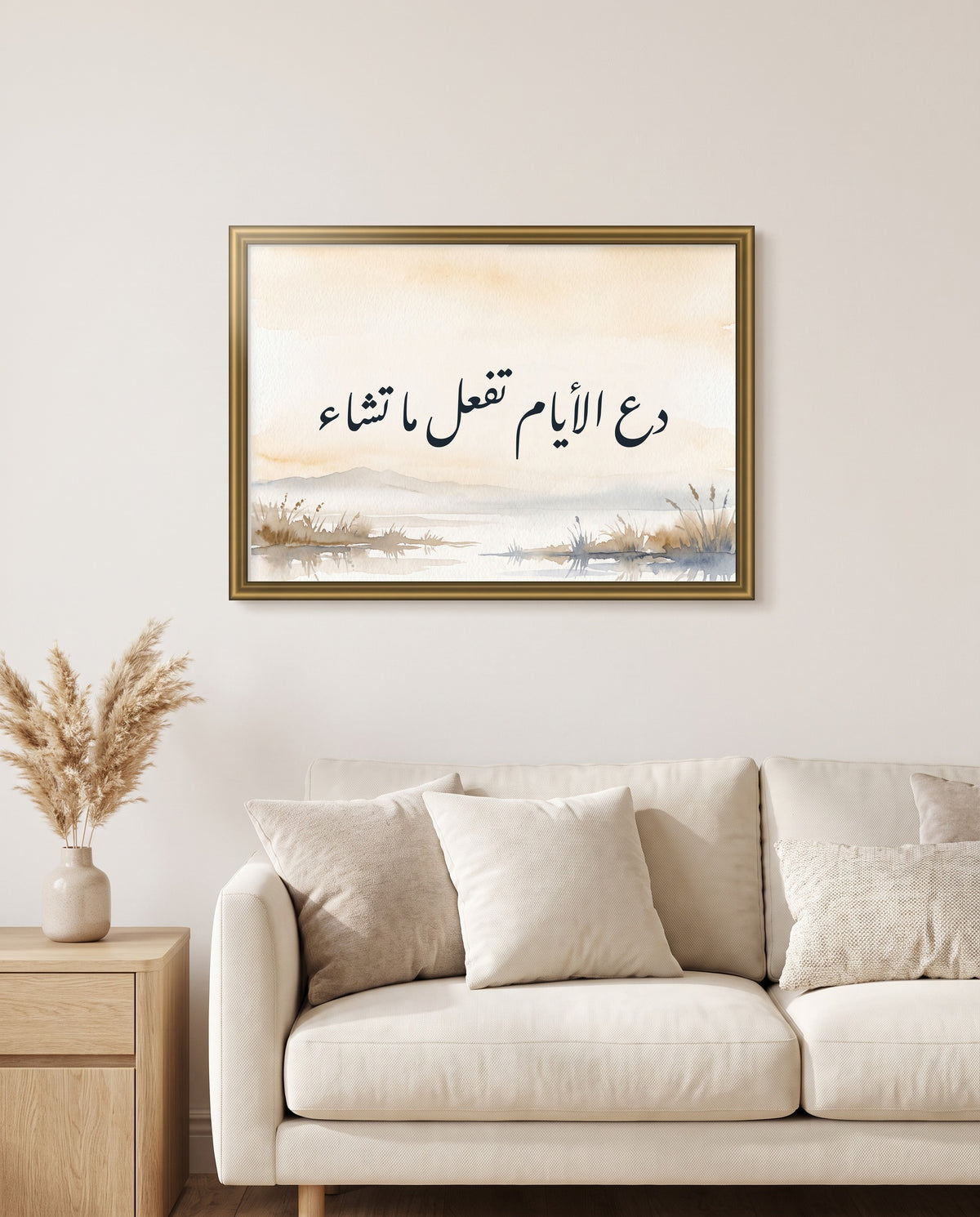 Let the Days Do as They Will: Arabic poetry in Nastaliq calligraphy, framed in polished gold above a cream sofa in a living room