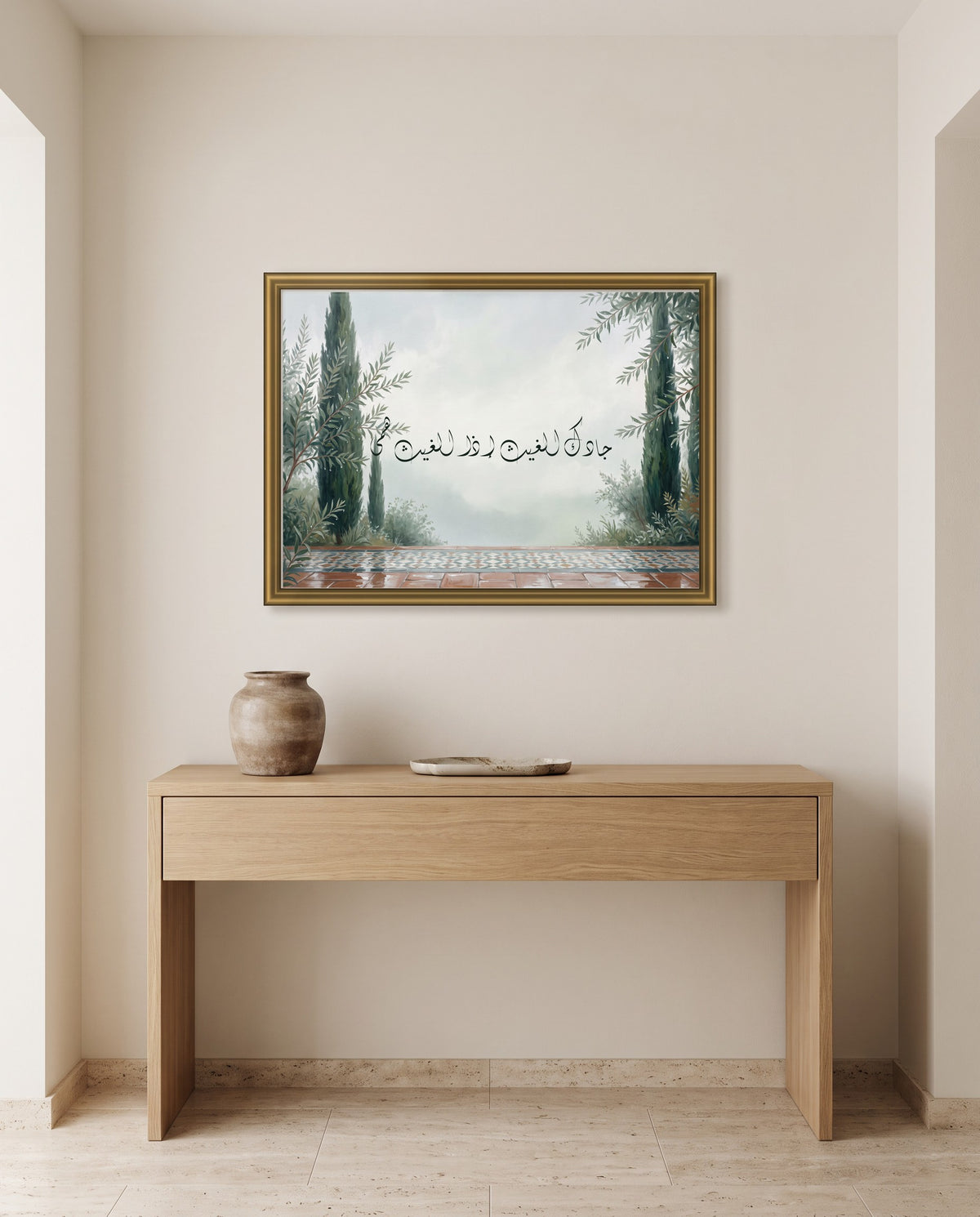 May the Rain Bless You Whenever It Falls: Arabic poetry in Diwani calligraphy, framed in polished gold above an oak console in an entrance hall