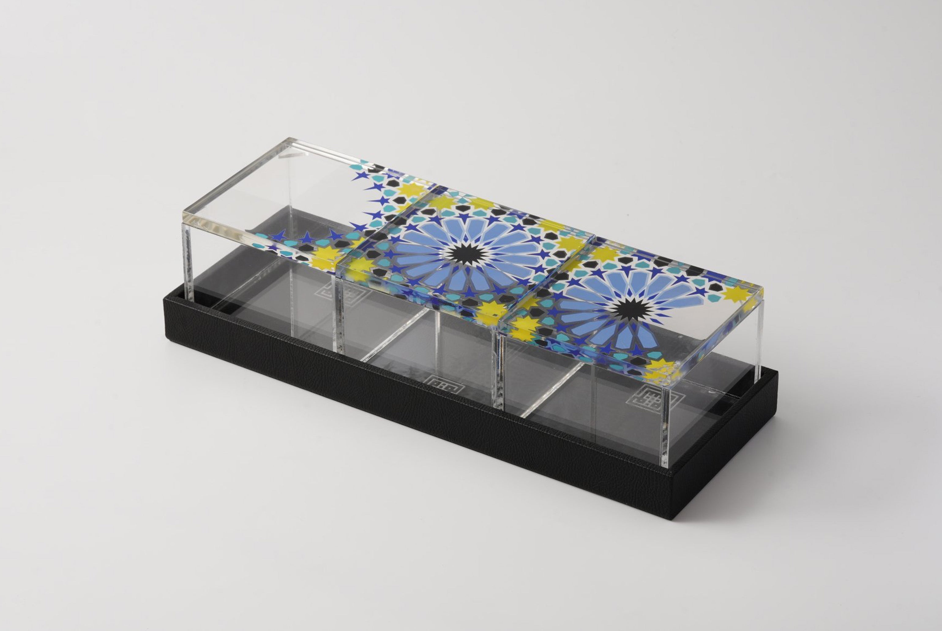 Arabesque acrylic desk storage box with a colourful geometric lid on a leather tray, by MASHQ Dubai
